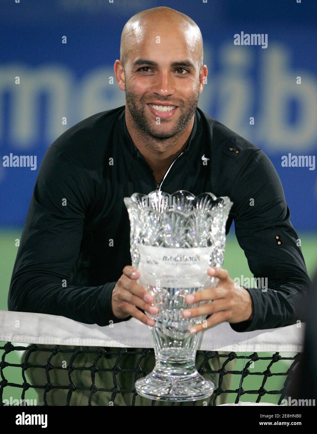 James Blake of the U.S. poses with his trophy after defeating Carlos Moya of Spain to win the Men's Singles title of the Sydney International tennis tournament at Olympic Park in Sydney January 13, 2007. REUTERS/Will Burgess  (AUSTRALIA) Stock Photo