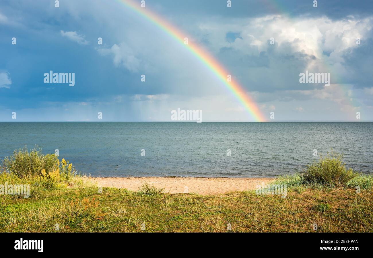 Thunderstorm with rain shower and rainbow over the Baltic Sea off the