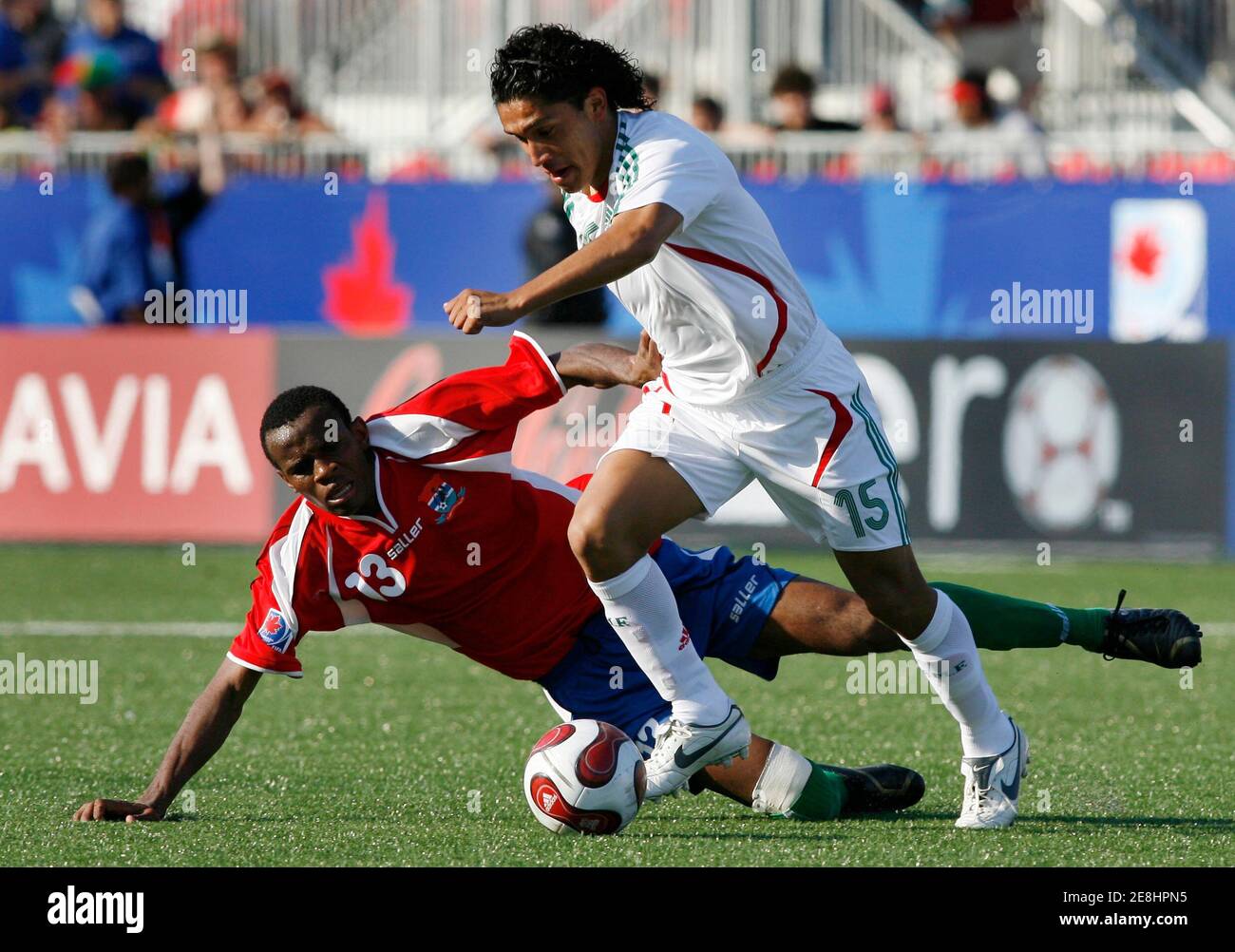 Mexico's Juan Carlos Silva (R) dribbles past Gambia's Ousman Jallow during  their match at the FIFA Under-20 World Cup soccer tournament in Toronto  July 2, 2007. Mexico defeated Gambia. REUTERS/J.P. Moczulski (CANADA