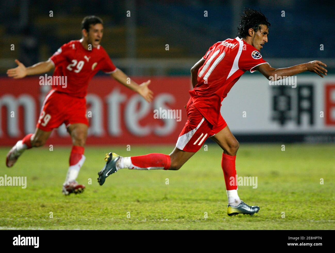 Bahrain's Ismaeel Abdullatif (R) and Abbas Ahmed react after a second goal during their 2007 AFC Asian Cup Group D soccer match against South Korea in Jakarta July 15, 2007. REUTERS/Beawiharta (INDONESIA) Stock Photo