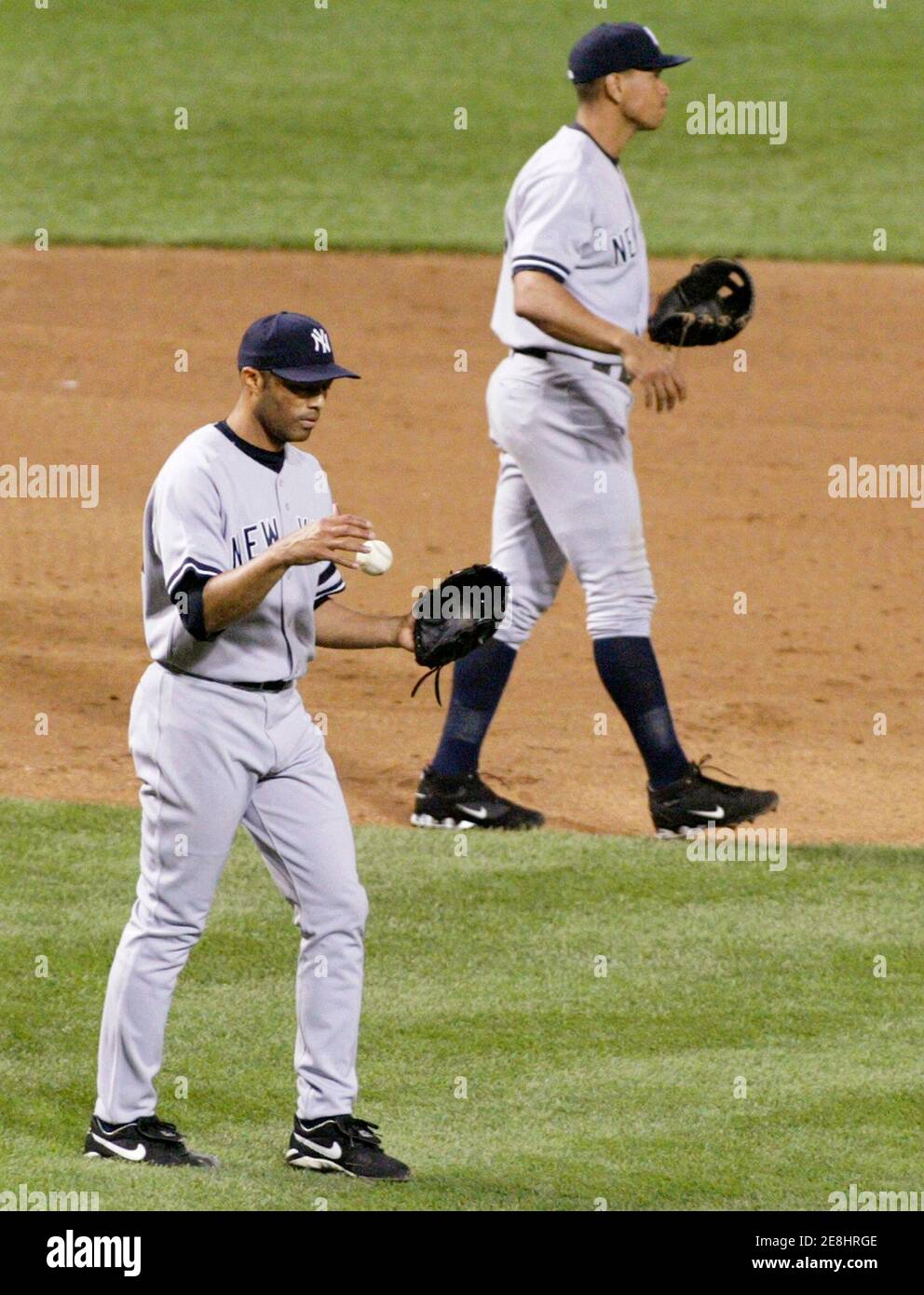 New York Yankees relief pitcher Mariano Rivera (L) flips the baseball in the air while third baseman Alex Rodriguez walks away after Rivera gave up a bases-loaded triple to Baltimore Orioles batter Jay Payton that tied the game in the ninth inning of their MLB American League baseball game in Baltimore, Maryland September 28, 2007.     REUTERS/Gary Cameron    (UNITED STATES) Stock Photo