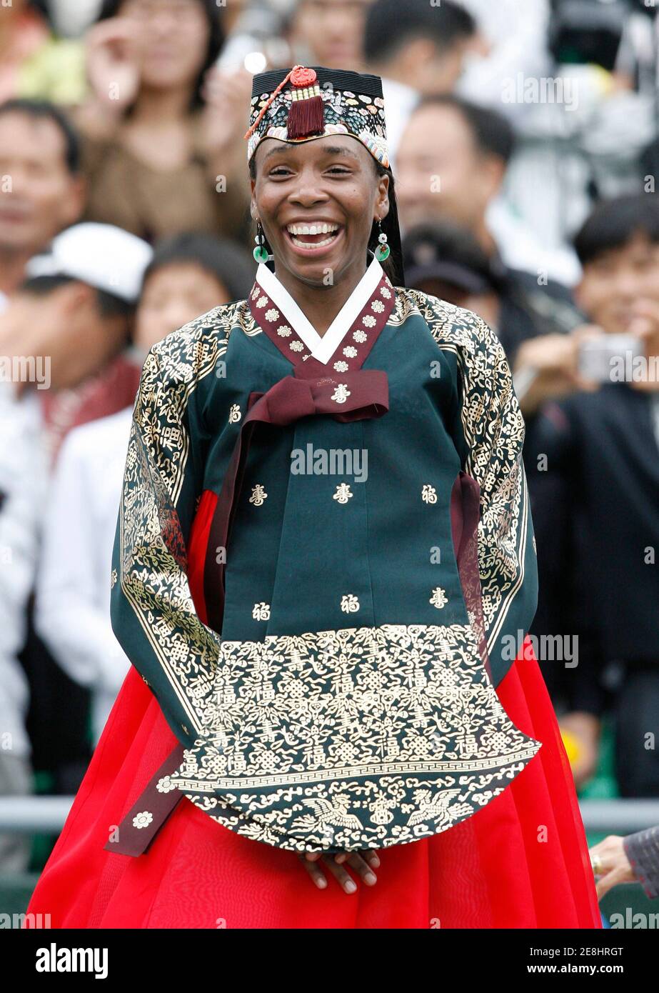 Venus Williams of the U.S. wearing a South Korean traditional dress smiles after her winning the match against Maria Kirilenko of Russia at the Korea Open tennis tournament final in Seoul September 30, 2007.  REUTERS/Jo Yong-Hak (SOUTH KOREA) Stock Photo