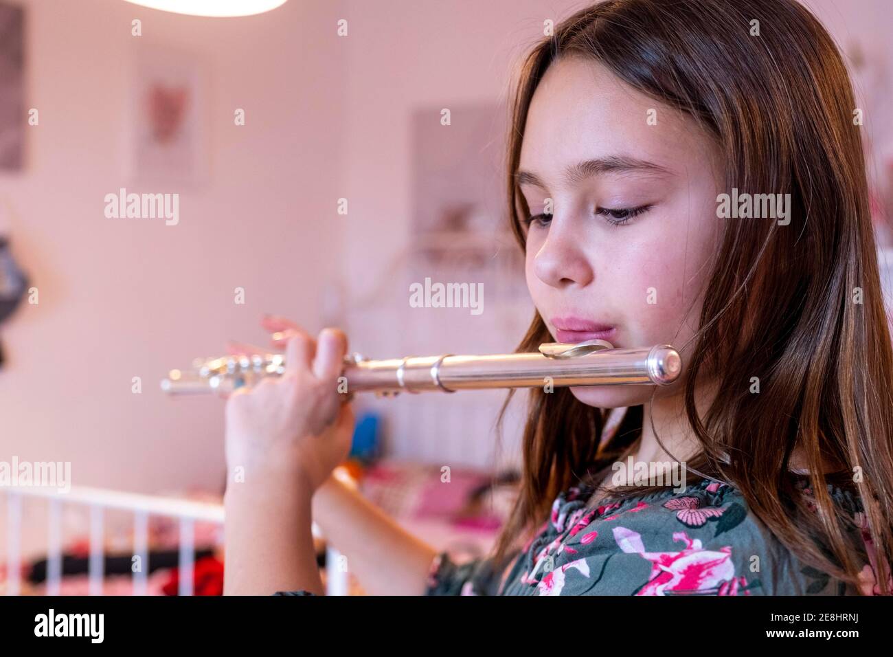Girl playing flute, learning musical instrument, Bavaria, Germany Stock
