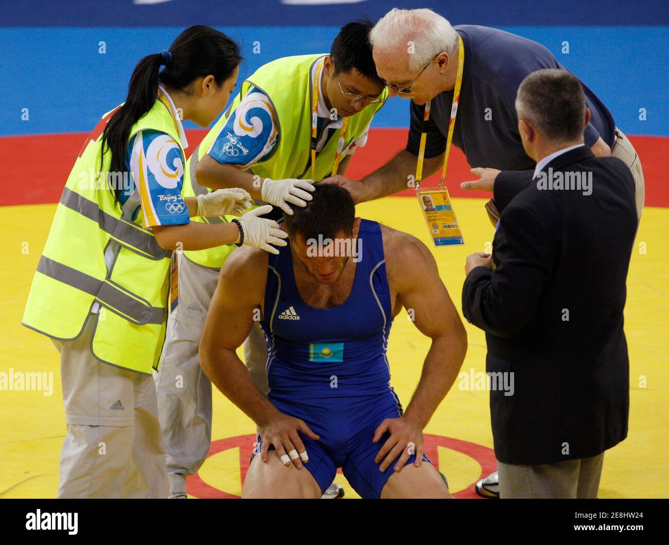 Taimuraz Tigiyev of Kazakhstan has his head checked after being injured during his 96kg men's freestyle wrestling semi-final match  against George Gogshelidze of Georgia at the Beijing 2008 Olympic Games August 21, 2008. REUTERS/Oleg Popov (CHINA) Stock Photo