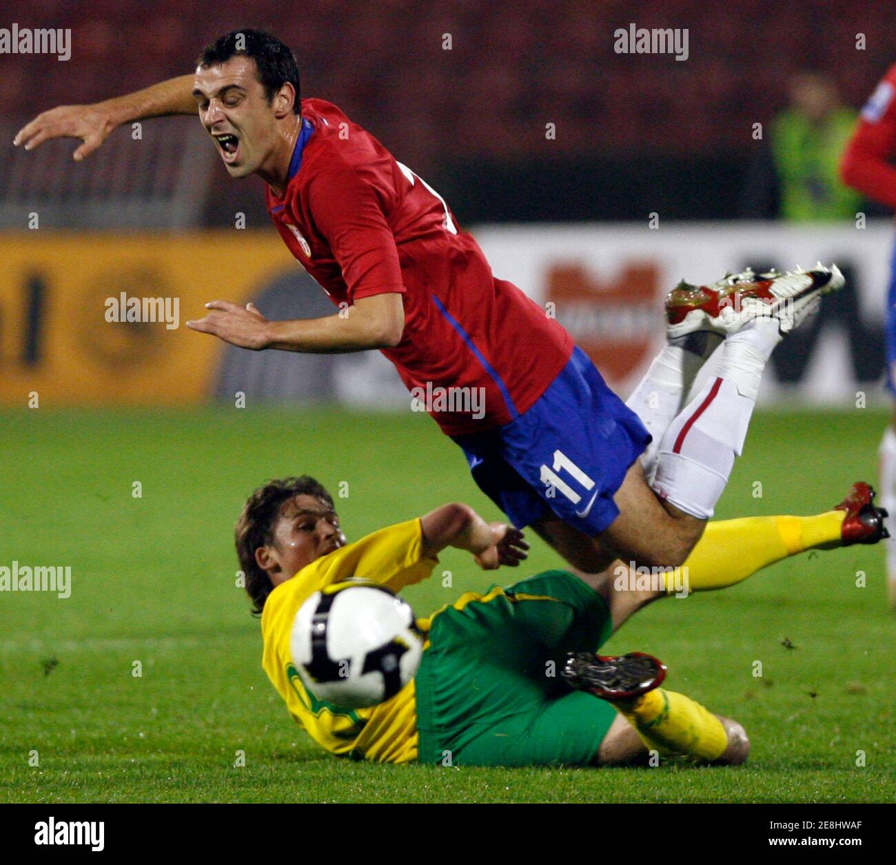 Serbia's Nenad Milijas (L) battles for the ball with Lithuania's Sauliks Makoliunas during their FIFA World Cup 2010 qualifying match in Belgrade, October 11, 2008.   REUTERS/Ivan Milutinovic (SERBIA) Stock Photo