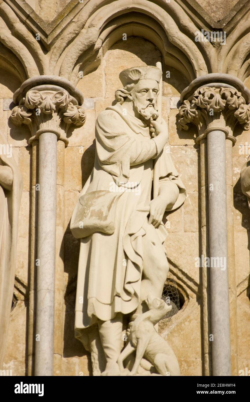 Victorian statue of Saint Roch revealing the plague mark on his thigh.  Sculpture by James Redfern and on public display on the West Front of Salisbur Stock Photo