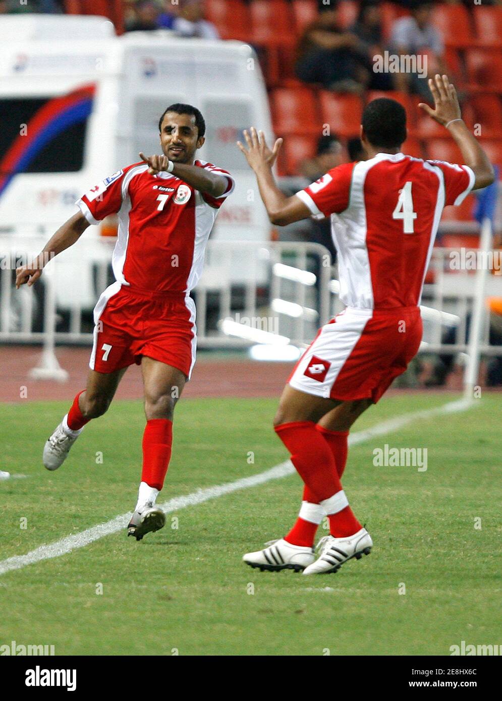 Oman's Ismail Sulaiman Al-Ajmi (L) celebrates with teammate Khuhfa Ayil Salim Al Naufh (4) after scoring a goal against Thailand during their 2010 World Cup qualifying soccer match in Bangkok March 26, 2008. REUTERS/Chaiwat Subprasom   (THAILAND) Stock Photo