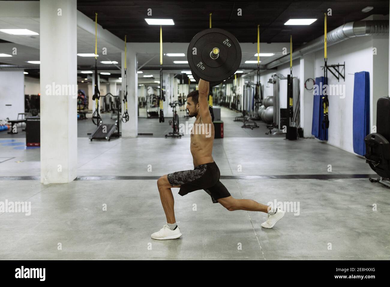 Side view of full body of strong young muscular male athlete in ...