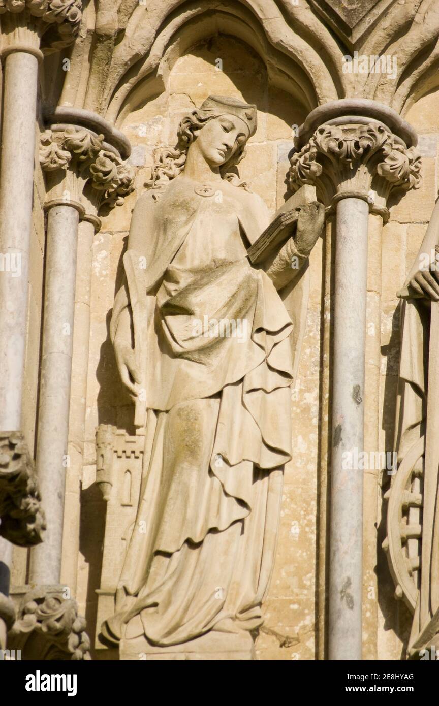 Victorian sculpture of the martyr Saint Barbara with the tower she was kept in on the West Front of Salisbury Cathedral, Wiltshire. Monument on public Stock Photo