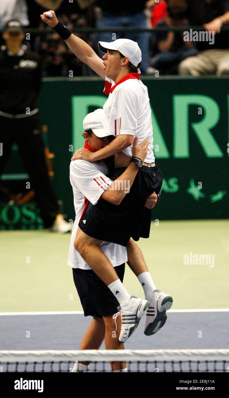 Mike Bryan of the U.S. leaps into the arms of his brother and partner Bob  Bryan upon defeating Yves Allegro and Stanislas Wawrinka of Switzerland  during their Davis Cup doubles tennis match