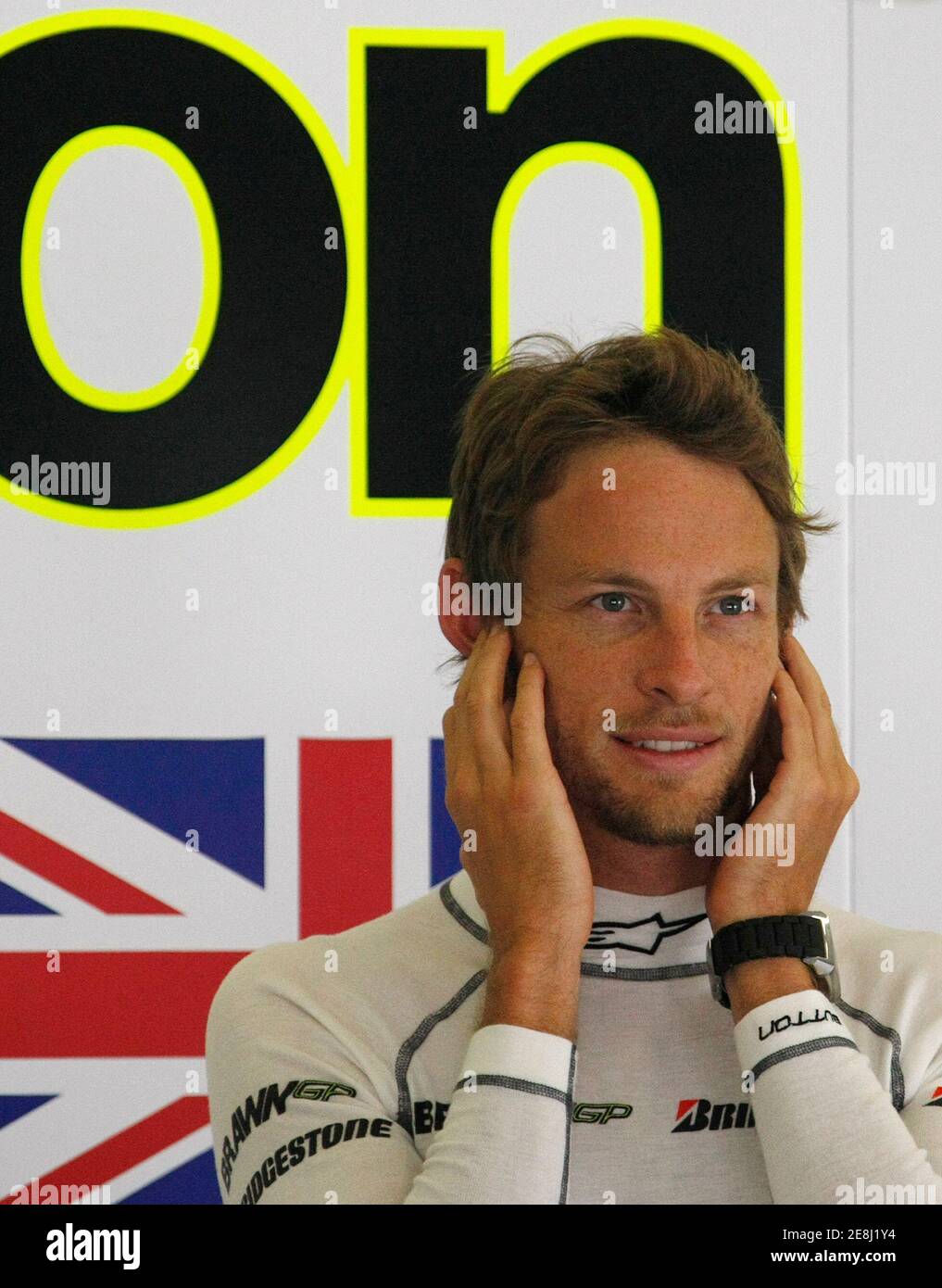 Brawn GP Formula One driver Jenson Button of Britain covers his ears in the pit box during the second practice session for the Turkish F1 Grand Prix at the Istanbul Park racetrack in Istanbul, June 5, 2009.  REUTERS/Pascal Lauener (TURKEY SPORT MOTOR RACING) Stock Photo