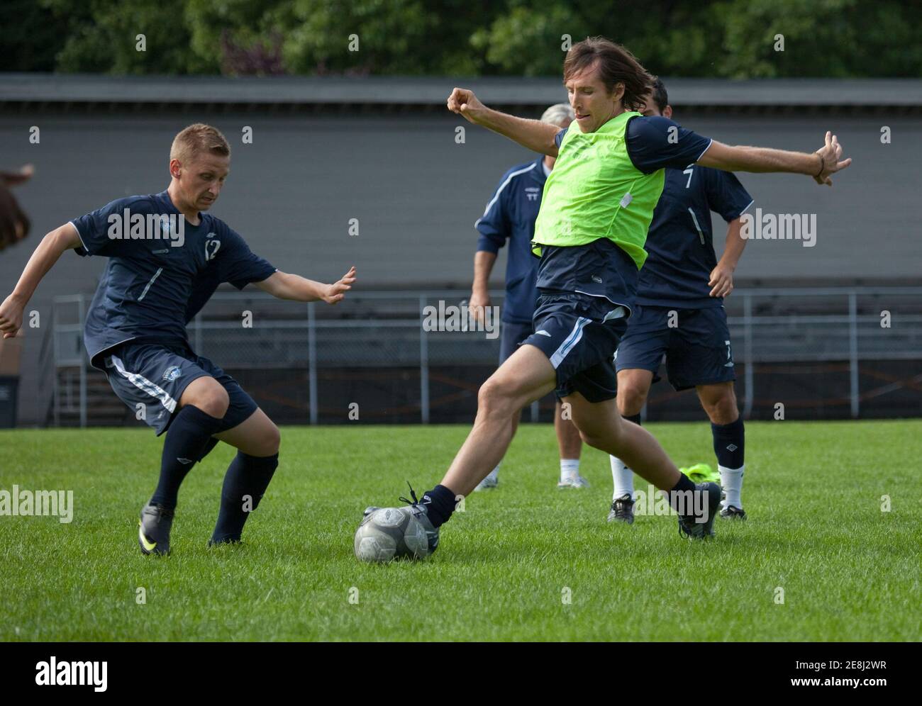 NBA star Steve Nash (R) chases the ball while training with young prospect players for the Vancouver Whitecaps FC in Vancouver, British Columbia September 17, 2009. Nash will be playing a celebrity benefit game on Saturday.        REUTERS/Andy Clark   (CANADA SPORT SOCCER BASKETBALL) Stock Photo