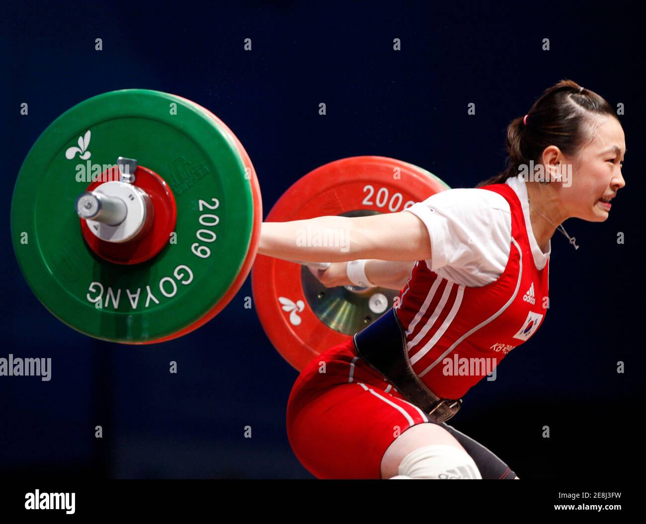 Yoon Jin-hee of South Korea drops the weights as she makes an unsuccessful attempt in the women's 53kg Group A weightlifting snatch competition at the World Weightlifting Championship in Goyang, north of Seoul, November 22, 2009.  REUTERS/Jo Yong-Hak (SOUTH KOREA SPORT WEIGHTLIFTING) Stock Photo