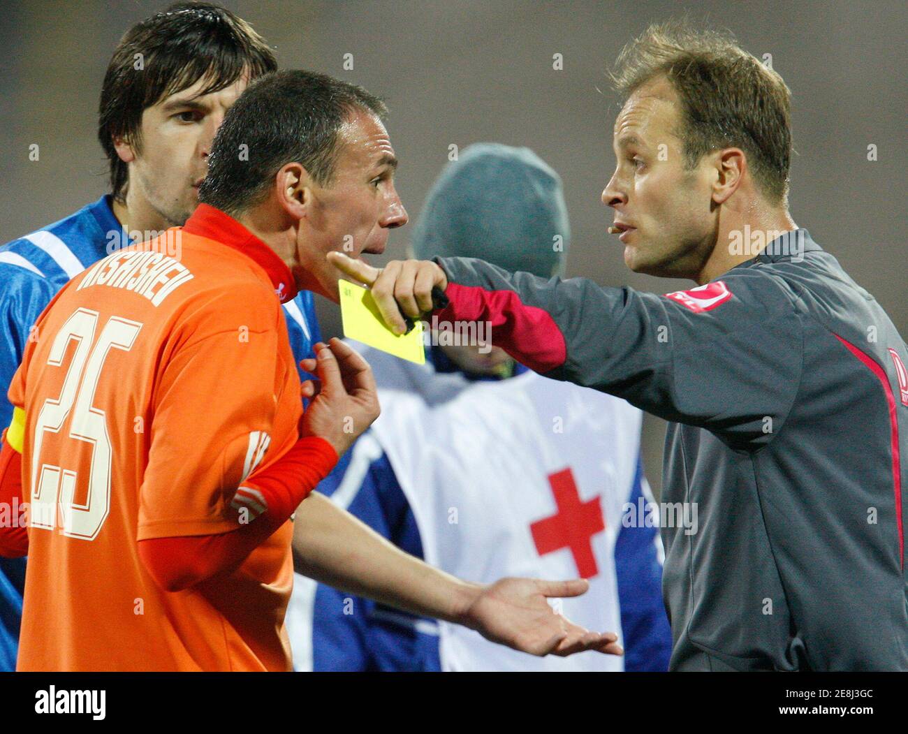 Litex Lovetch's Radostin Kishishev (L) argues with the referee after receiving a yellow card during his team's Bulgarian League soccer match against Levski Sofia at Georgy Asparuhov stadium in Sofia November 25, 2009.   REUTERS/Oleg Popov   (BULGARIA SPORT SOCCER) Stock Photo
