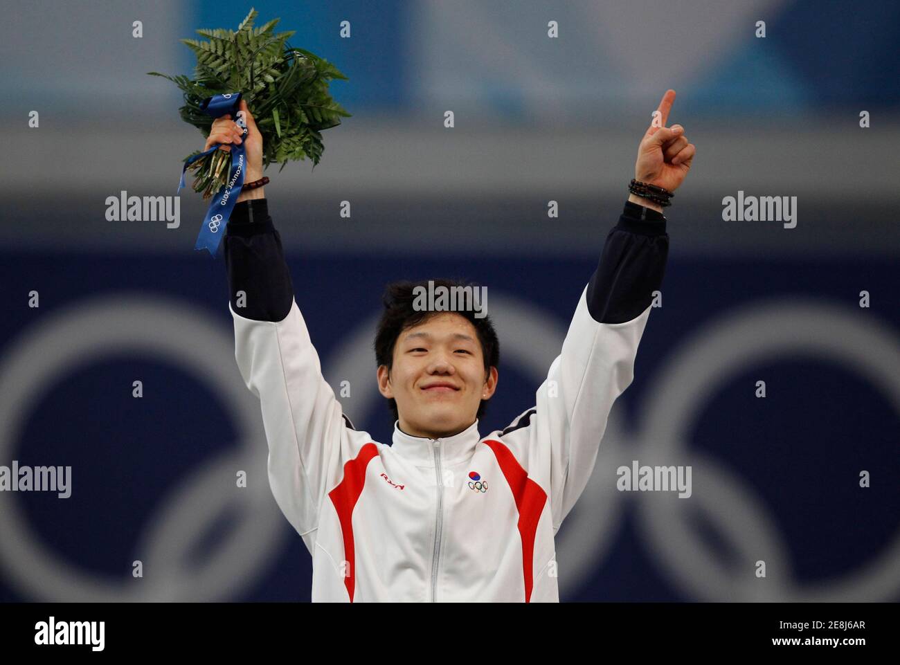 Mo Tae-bum of South Korea celebrates his victory during the flower ceremony following the men's 500 metres speed skating race at the Richmond Olympic Oval during the Vancouver 2010 Winter Olympics February 15, 2010.  REUTERS/Jerry Lampen (CANADA) Stock Photo