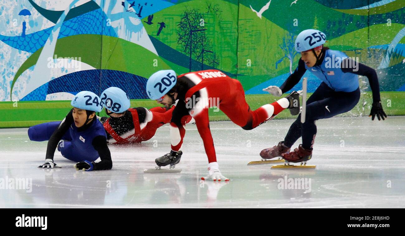 South Korea's Sung Si-bak (L) and Canada's Francois-Louis Tremblay crash as Canada's Charles Hamelin (2nd R) stumbles and Apolo Anton Ohno of the U.S. races during the men's 500 metres short track speed skating final at the Vancouver 2010 Winter Olympics February 26, 2010.     REUTERS/Jerry Lampen (CANADA) Stock Photo