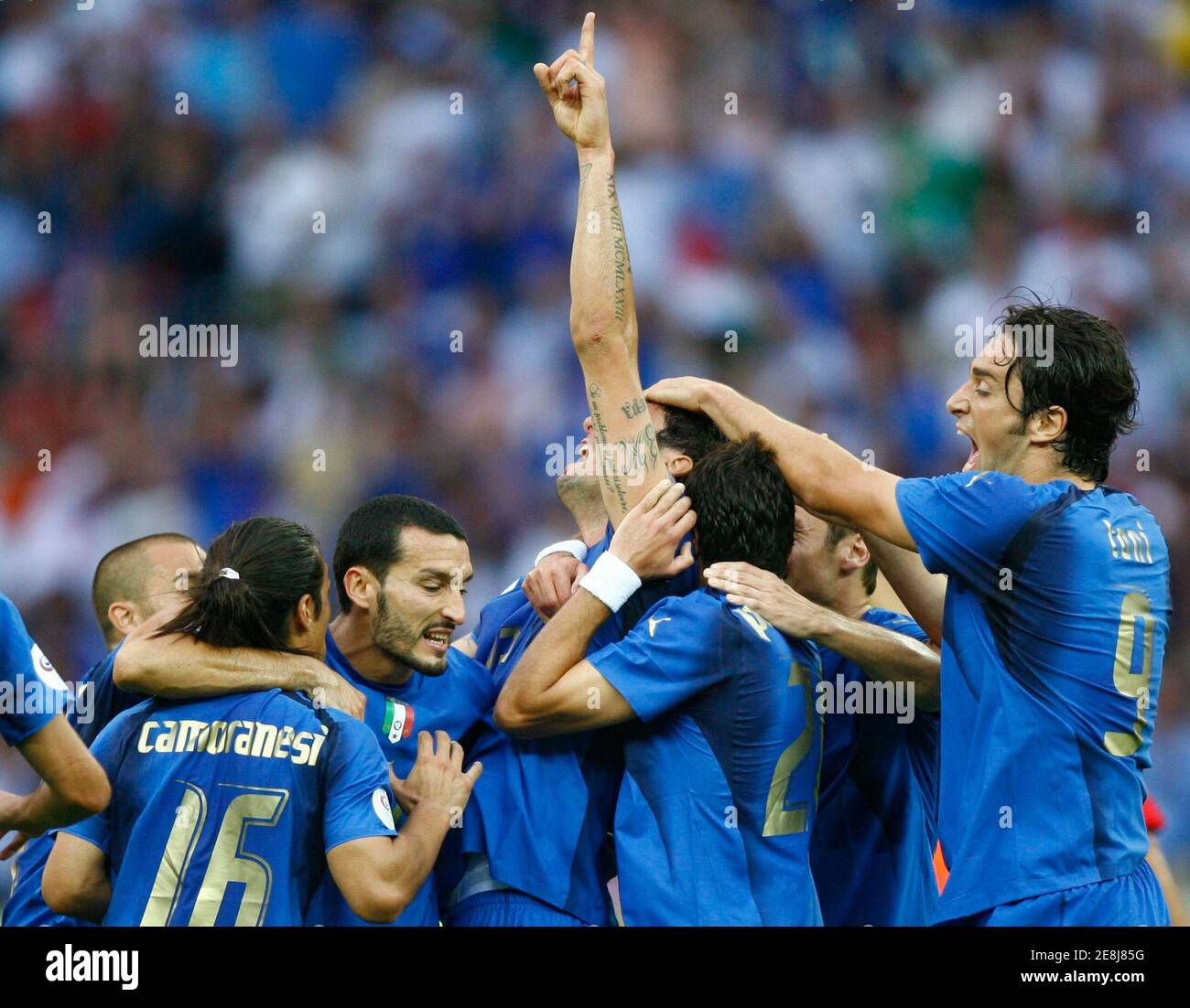 Italy's Marco Materazzi (arm raised) celebrates his goal against France with team mates during their World Cup 2006 final soccer match in Berlin July 9, 2006.  FIFA RESTRICTION - NO MOBILE USE     REUTERS/Jerry Lampen (GERMANY) Stock Photo