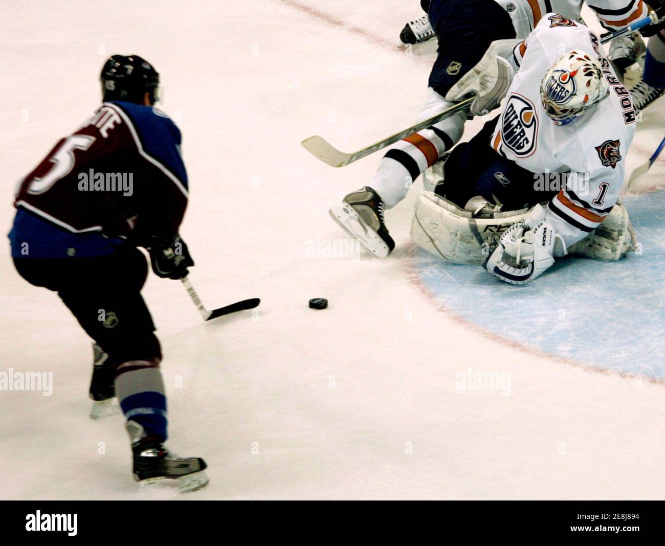 Colorado Avalanche winger Andrew Brunette (L) scores a goal past Edmonton Oilers goalie Michael Morrison (R) in the third period of NHL action in Denver, Colorado February 7, 2006. The Avlanche won the game 5 - 2. REUTERS/Rick Wilking Stock Photo