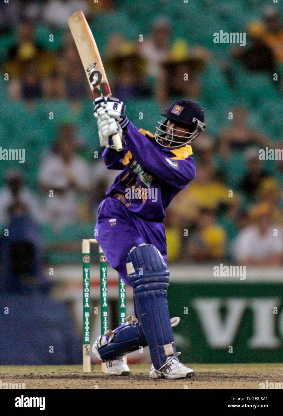 Sri Lanka's Russell Arnold hits a ball off Brett Lee of Australia during their second one-day cricket final in Sydney February 12, 2006. Australia won by 167 runs to level the series 1-1. REUTERS/Will Burgess1 Stock Photo