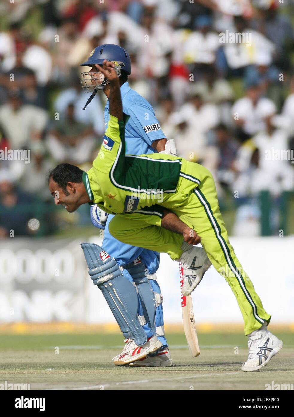 Pakistan's Rana Naved-ul-Hasan (front) bowls as India's captain Rahul Dravid prepares to run during their one-day international cricket match at the Zayed cricket stadium in Abu Dhabi, United Arab Emirates, April 18, Pakistan's Rana Naved-ul-Hasan (front) bowls as India's captain Rahul Dravid prepares to run during their one-day international cricket match at the Zayed cricket stadium in Abu Dhabi, United Arab Emirates, April 18,