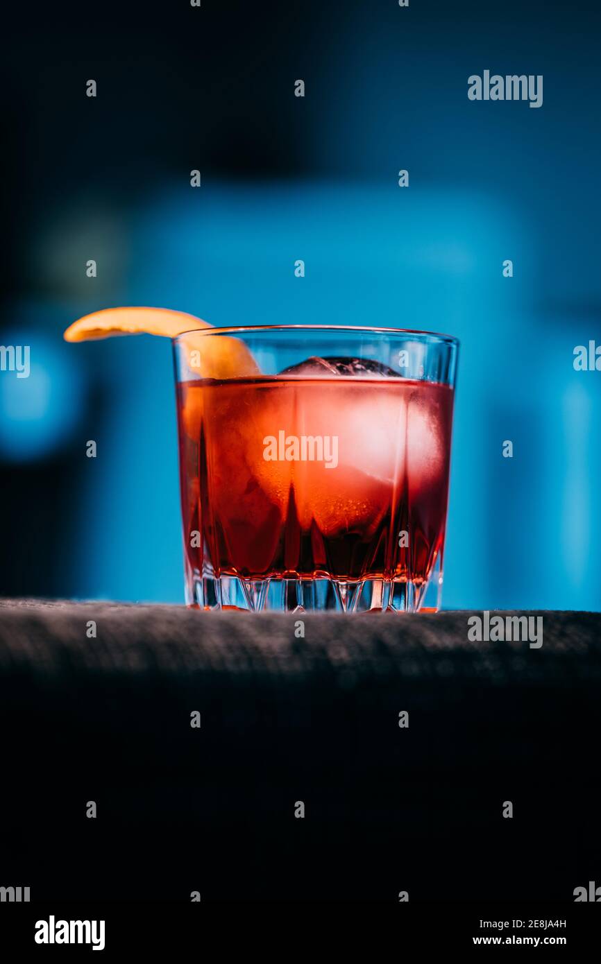 Glass of refreshing Negroni cocktail with bitter flavor and ice