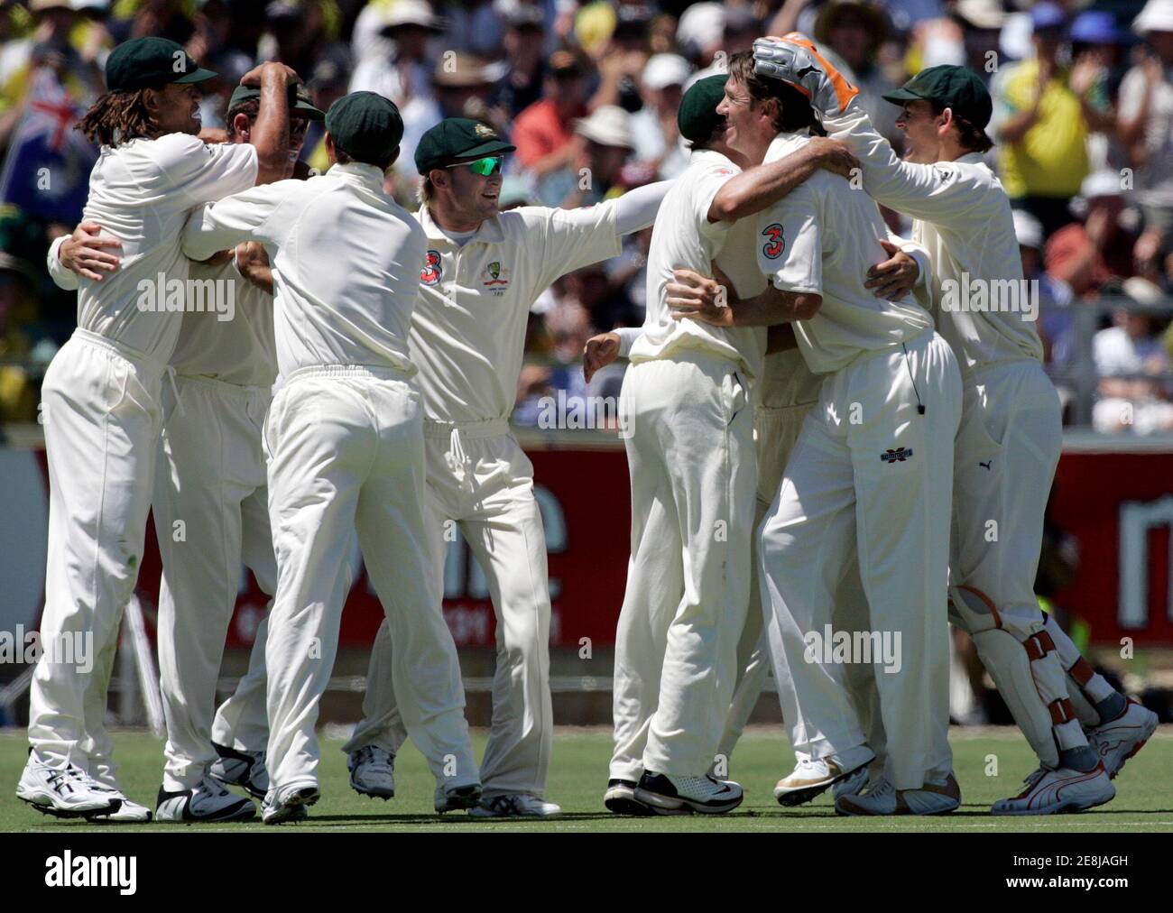 Australia's Glenn McGrath (2nd R) celebrates with team mates after having England's Paul Collingwood caught for 11 runs on the second day of the third Ashes test in Perth December 15, 2006. MOBILES OUT  EDITORIAL USE ONLY  REUTERS/Will Burgess  (AUSTRALIA) Stock Photo