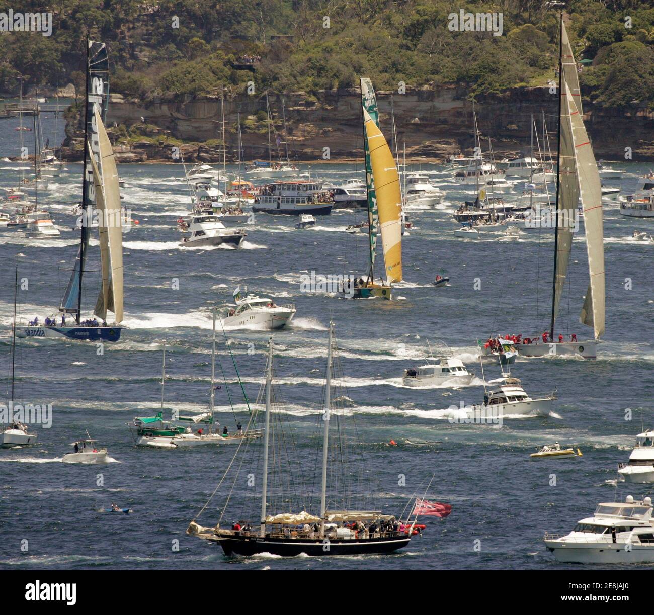 Wild Oats XI (R) leads Skandia (L) and ABN AMRO (C) as they negotiate part of the spectator fleet after the start of the annual Sydney to Hobart yacht race in Sydney December 26, 2006. REUTERS/Will Burgess (AUSTRALIA) Stock Photo