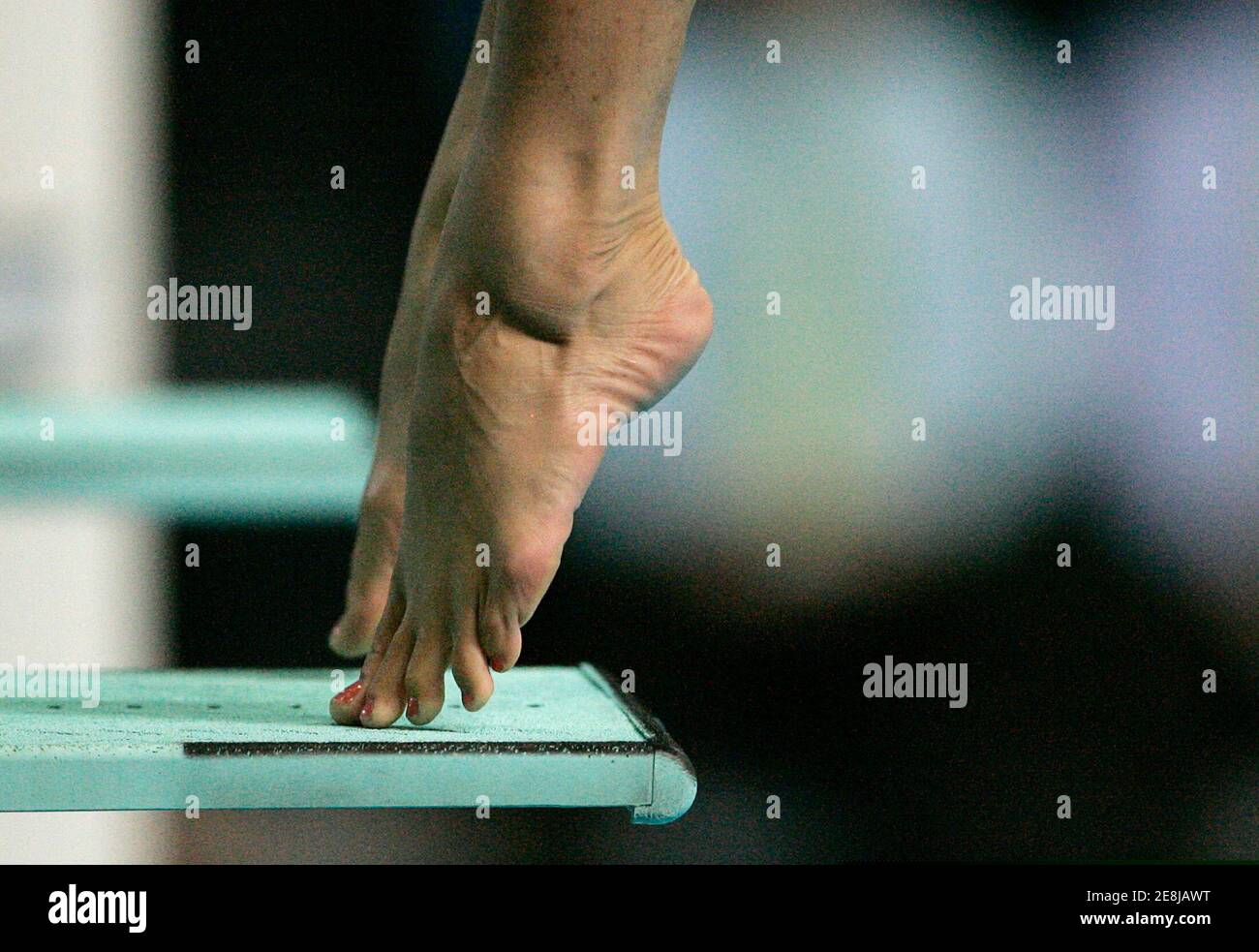 The feet of South African diver Jenna Dreyer push away from the 3M springboard during the women's competition at the Commonwealth Games in Melbourne, Australia March 25, 2006. Dreyer placed 10th in the competition. Stock Photo
