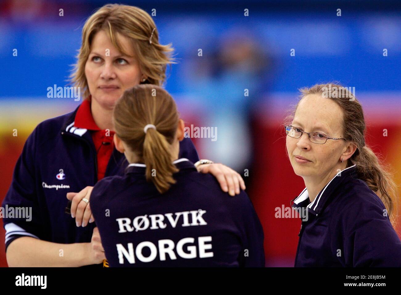 Norway's Dordi Nordby (R), Marianne Halsum (L) and Marianne Roervik stand during their loss to Canada during the women's curling bronze medal match at the Torino 2006 Winter Olympic Games in Pinerolo, Italy, February 23, 2006. Canada defeated Norway 11-5 in eight ends of play. REUTERS/Jerry Lampen Stock Photo