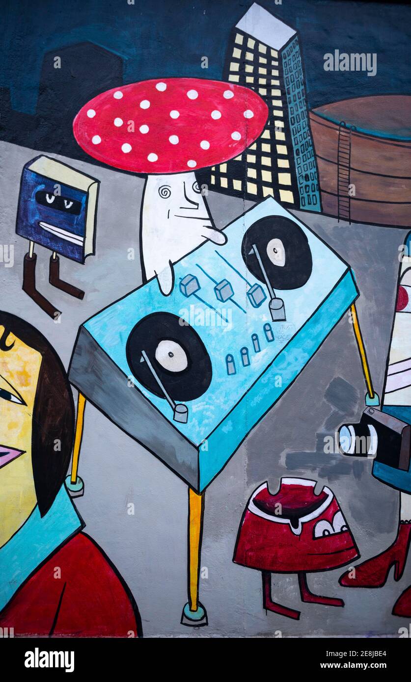 Mural toadstool as DJ at the mixing desk, artist Jim Avignon, mural at the East Side Gallery, Friedrichshain, Berlin, Germany Stock Photo