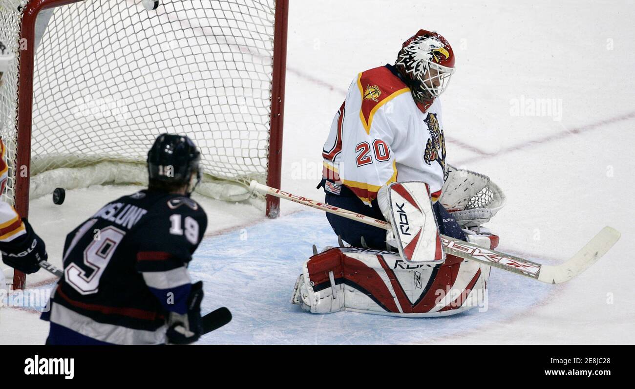 Vancouver Canucks Markus Naslund (C) watches the puck go past Florida Panthers goalie Ed Belfour during third period NHL hockey play in Vancouver, British Columbia January 7, 2007.         REUTERS/Andy Clark     (CANADA) Stock Photo