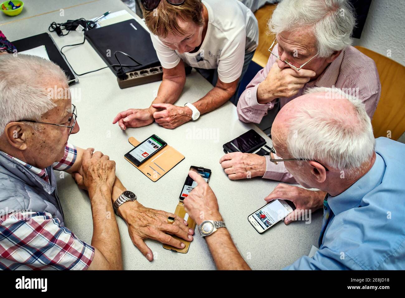 Seniors self-help dealing with computer, internet, smarthphone. Karlsruhe, Baden-Wuerttemberg, Germany Stock Photo