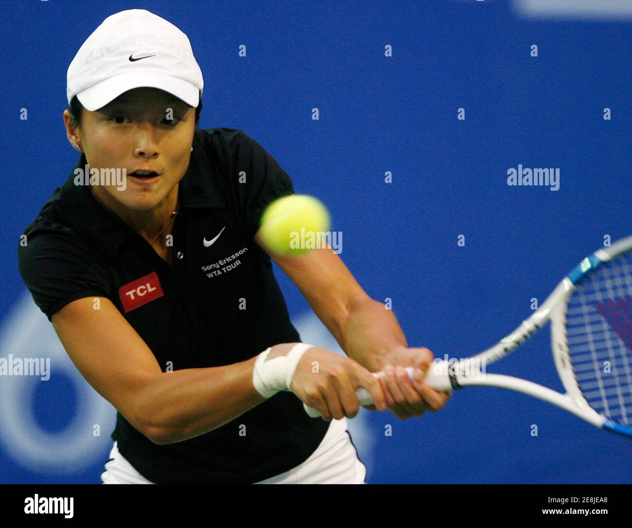 Zi Yan of China returns a shot to Jelena Jankovic of Serbia during their first round tennis match at the Bangkok Open October 10, 2007. REUTERS/Chaiwat Subprasom (THAILAND) Stock Photo