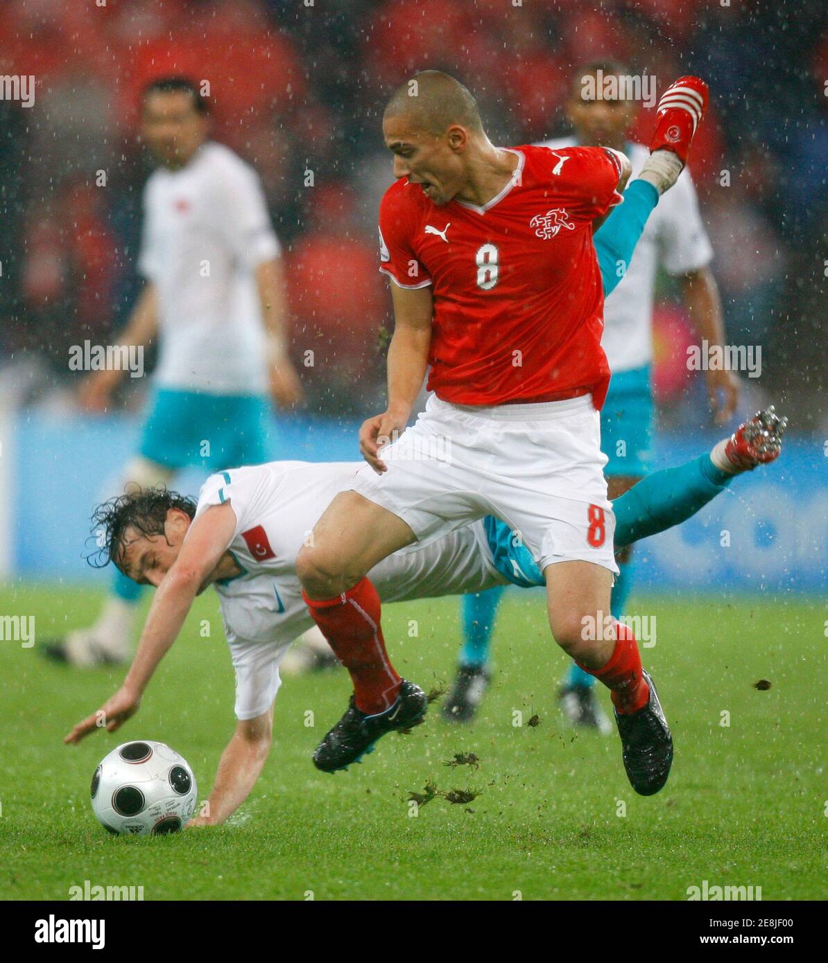 Switzerland's Gokhan Inler (R) is challenged by Turkey's Tuncay Sanli during their Group A Euro 2008 soccer match at St Jakob Park in Basel, June 11, 2008.     REUTERS/Jerry Lampen (SWITZERLAND)     MOBILE OUT. EDITORIAL USE ONLY Stock Photo