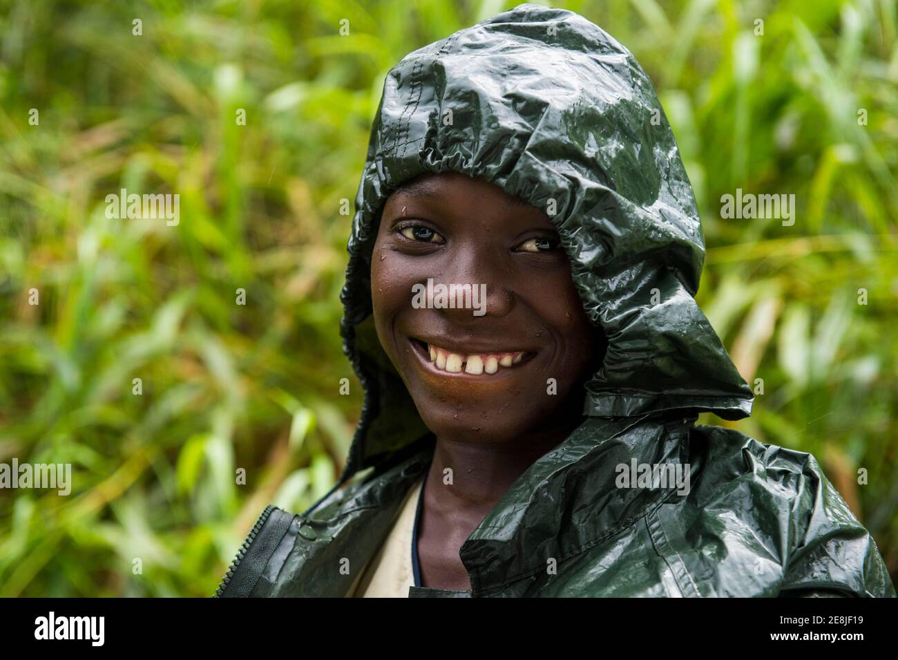 Pretty girl wearing a raincape smiling, Sao Tome, Sao Tome and Principe, Atlantic ocean Stock Photo