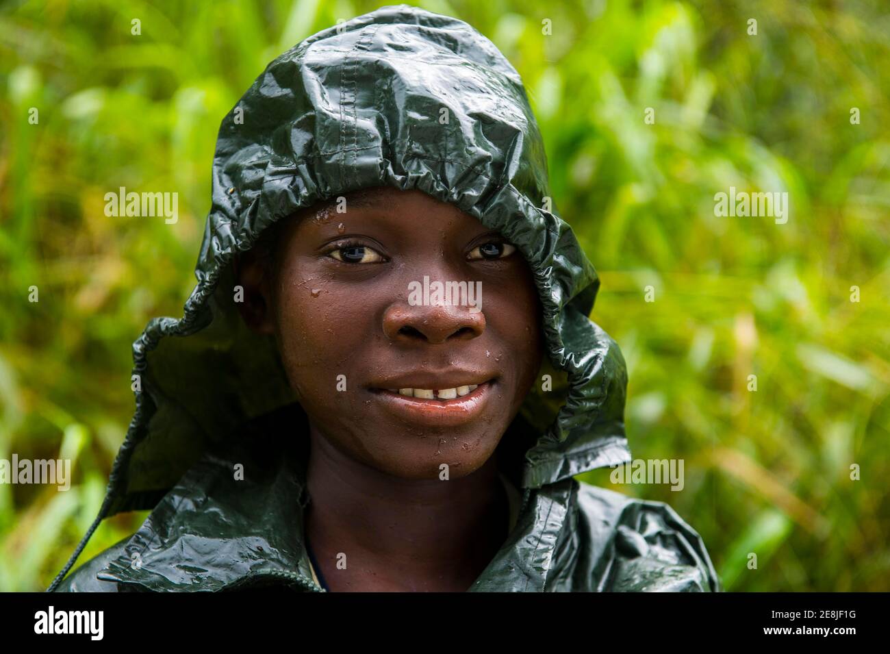 Pretty girl wearing a raincape smiling, Sao Tome, Sao Tome and Principe, Atlantic ocean Stock Photo