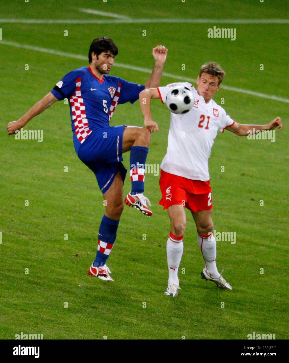 Croatia's Vedran Corluka (L) challenges Poland's Tomasz Zahorski during their Group B Euro 2008 soccer match at the Woerthersee Stadium in Klagenfurt June 16, 2008.     REUTERS/Miro Kuzmanovic (AUSTRIA)  MOBILE OUT. EDITORIAL USE ONLY Stock Photo