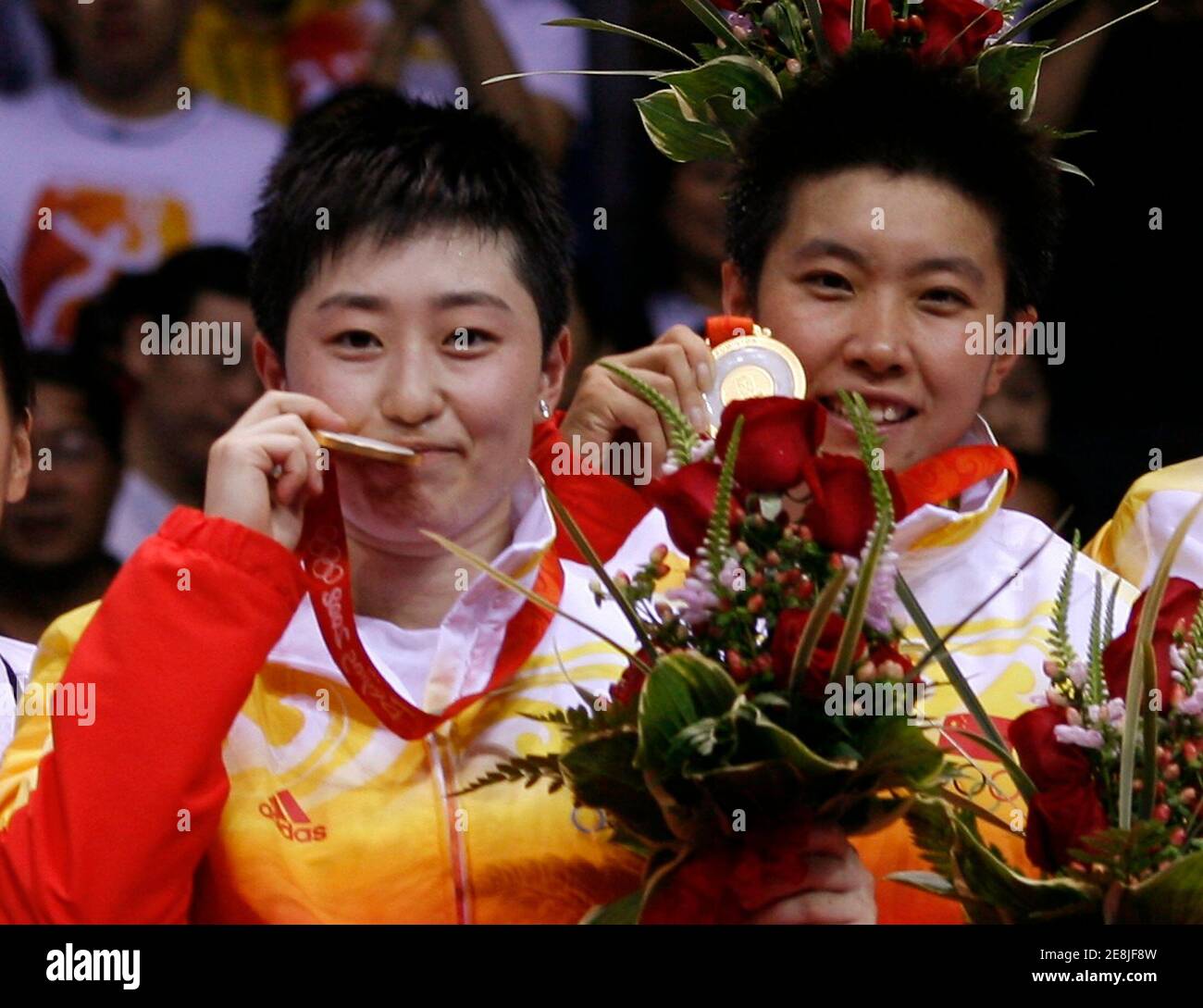Yu Yang (L) and Du Jing of China celebrate with their gold medals after winning their women's doubles badminton final against South Korea at the Beijing 2008 Olympic Games August 15, 2008.     REUTERS/Beawiharta (CHINA) Stock Photo
