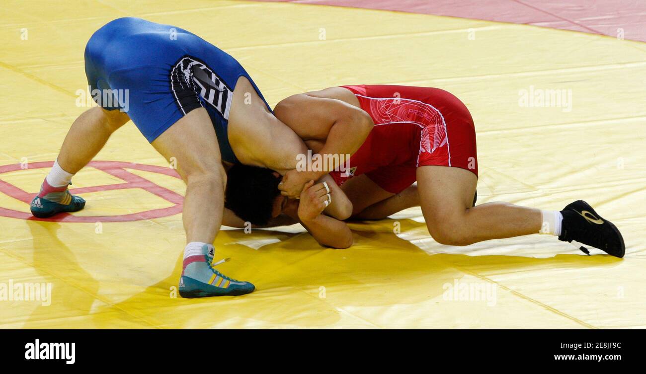 Kim Jae-Gang of South Korea (in red) fights Marid Mutalimov of Kazakhstan during their 120kg men's freestyle wrestling match at the Beijing 2008 Olympic Games, August 21, 2008. REUTERS/Oleg Popov (CHINA) Stock Photo