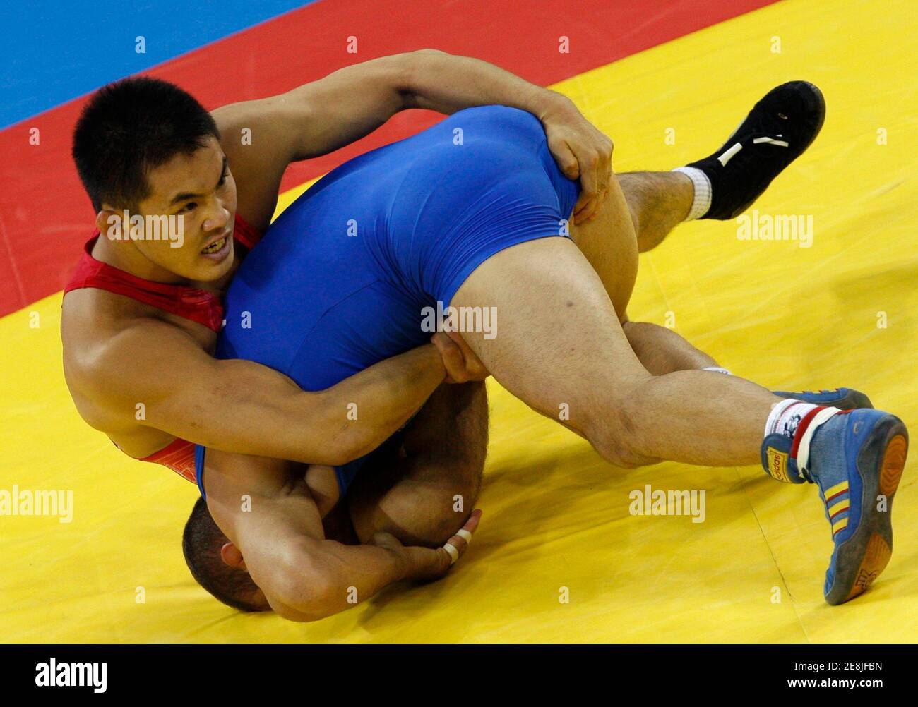 Jung Young-Ho of South Korea (in red) fights Serafim Bartzakov of Bulgaria during their 66kg men's freestyle wrestling 1/8 finals match at the Beijing 2008 Olympic Games August 20, 2008.     REUTERS/Oleg Popov (CHINA) Stock Photo