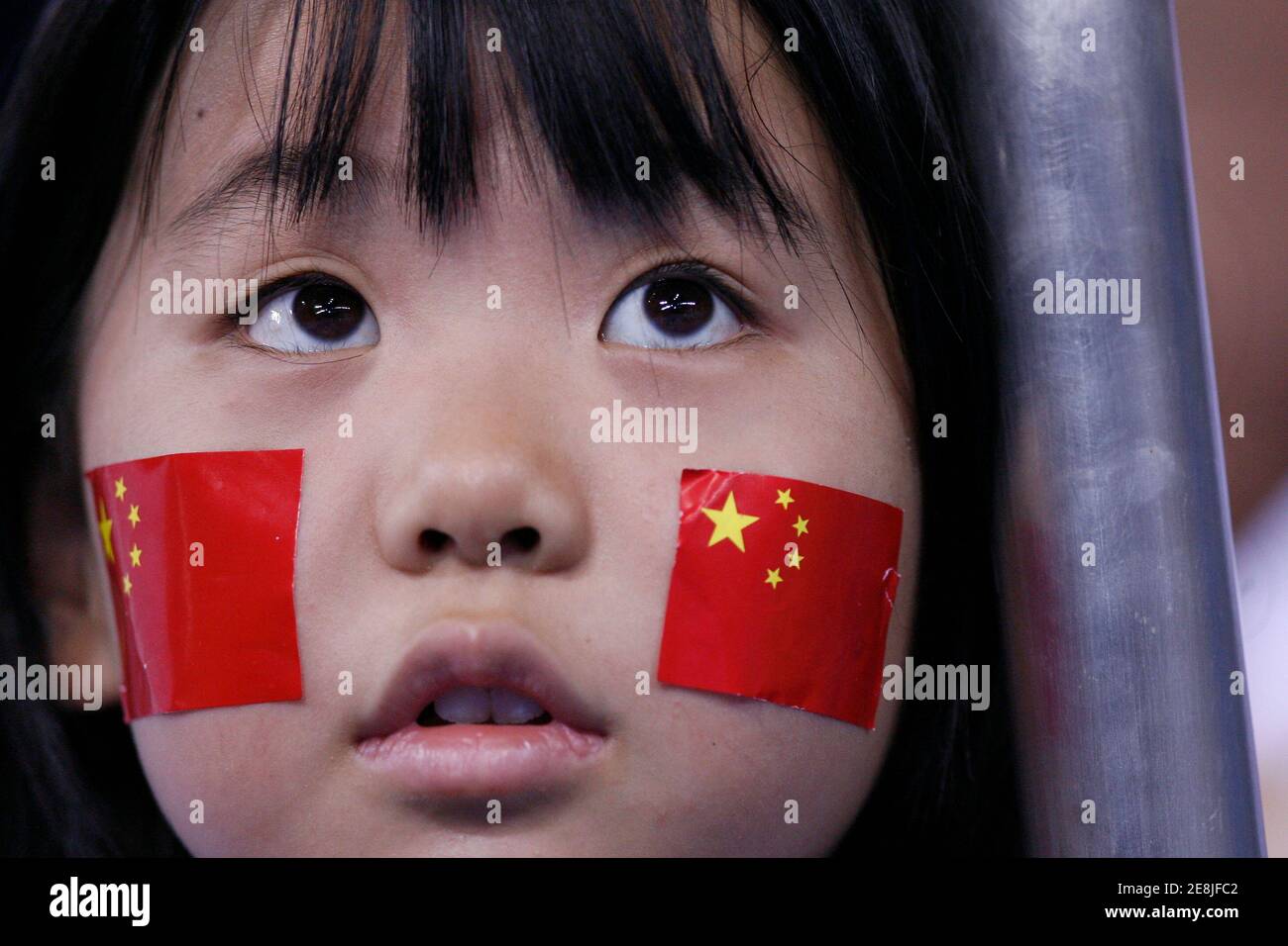 A young girl watches the men's singles quarterfinal table tennis match between Wang Hao of China and Ko Lai Chak of Hong Kong at the Beijing 2008 Olympic Games August 22, 2008.     REUTERS/Beawiharta (CHINA) Stock Photo