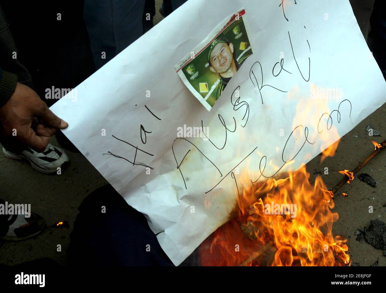 Indian cricket fans burn a newspaper clipping of Australian cricket captain  Ricky Ponting during a protest in Jammu January 7, 2008. India has reacted  with anger and disappointment at the standard of