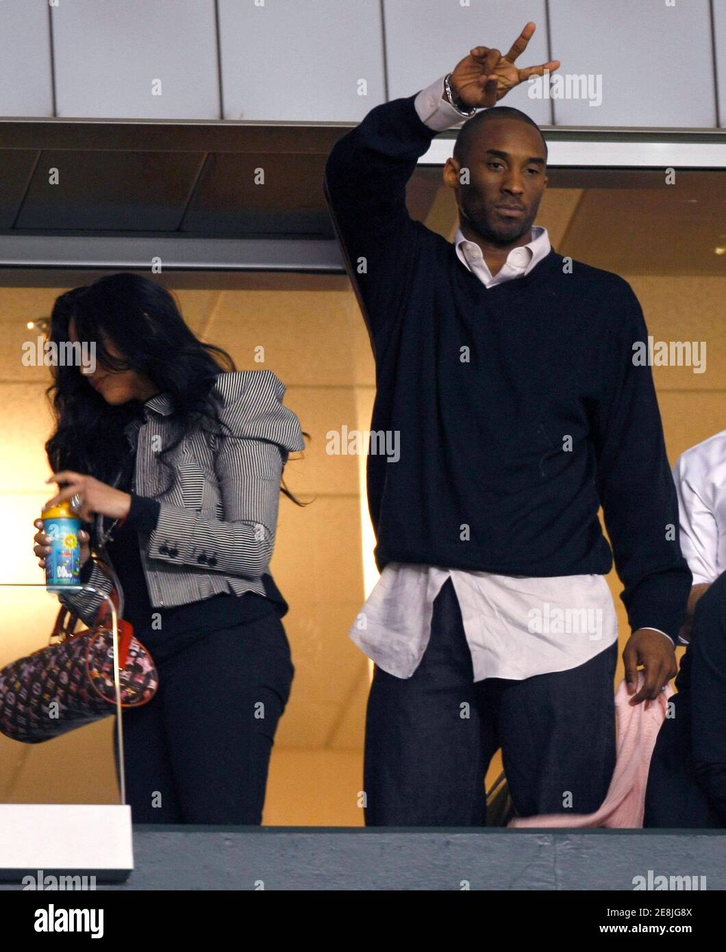 Basketball super star Kobe Bryant (R) waves to fans as he and wife Vanessa (L) leave the Major League Soccer game between the Los Angeles Galaxy and San Jose Earthquakes in Carson, California  April 3, 2008.    REUTERS/Mike Blake      (UNITED STATES) Stock Photo
