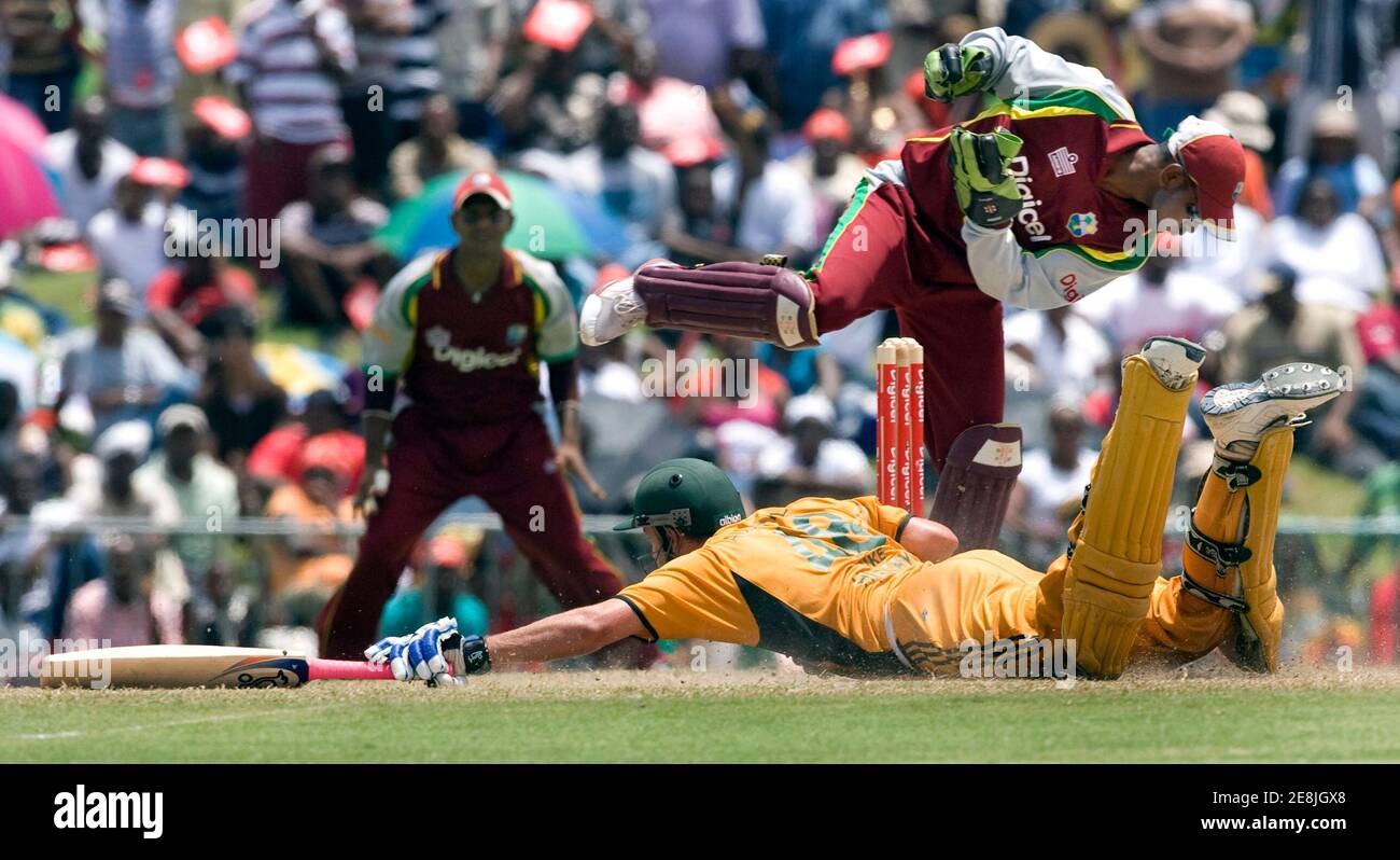 Australia's Michael Hussey dives for the crease as West Indies wicketkeeper Denesh Ramdin tries to run Hussey out during their final one-day cricket international in Basseterre, St. Kitts July 6, 2008.       REUTERS/Andy Clark        (ST KITTS) Stock Photo