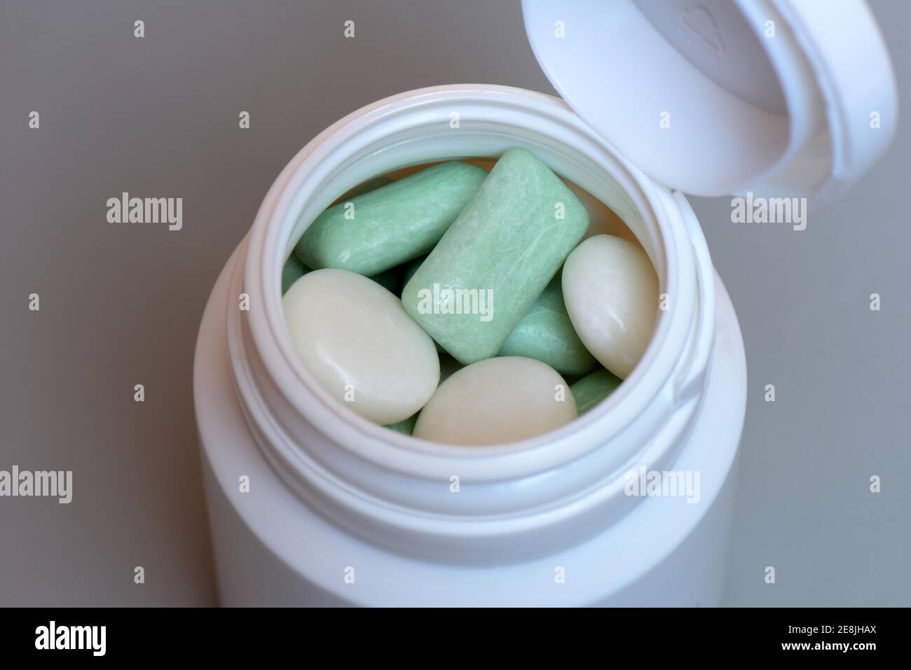 Various chewing gums in containers, chewing gum lozenges, dragees