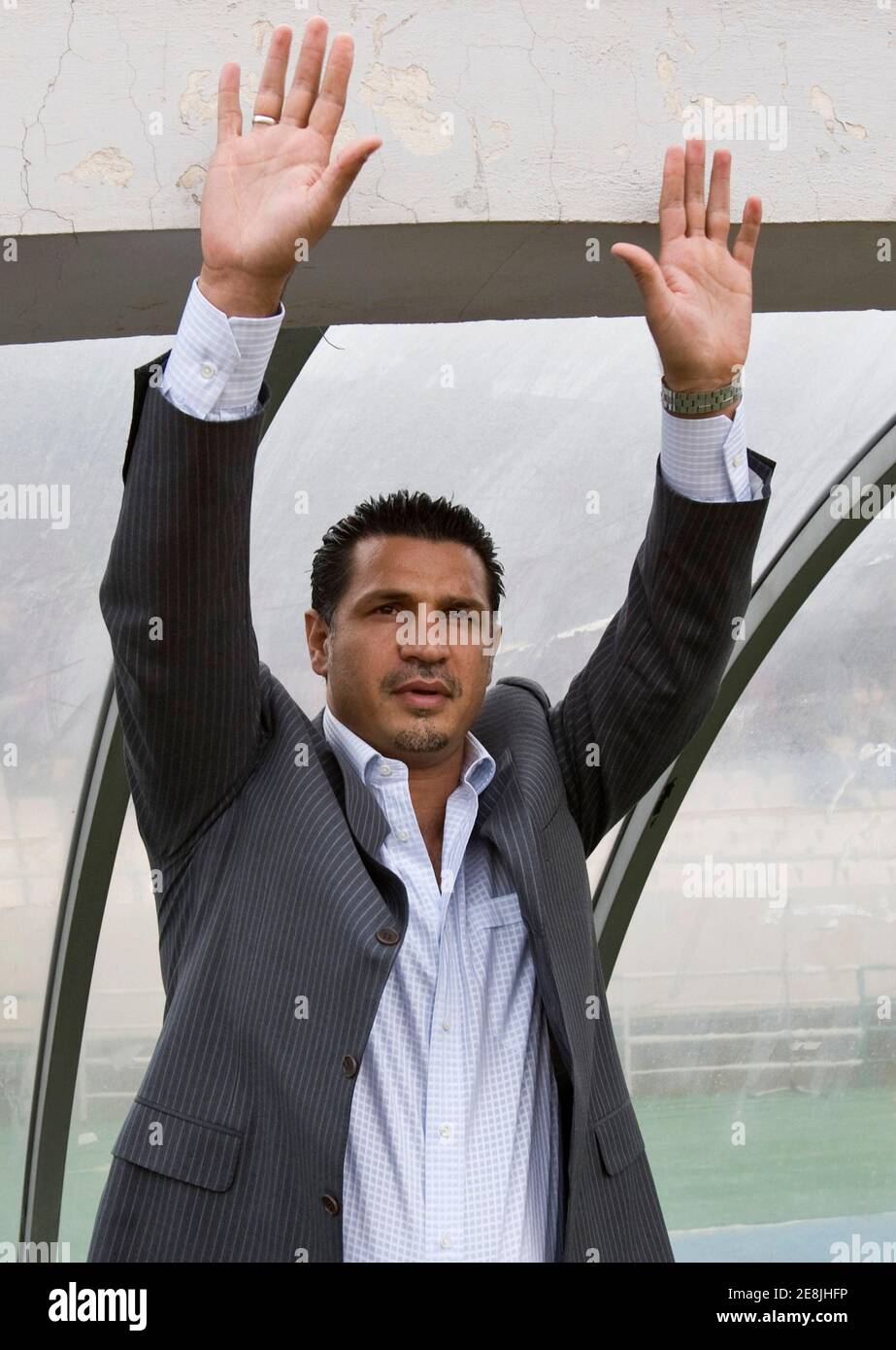 Iran's coach Ali Daei waves to fans before the start of their 2010 World Cup qualifying soccer match against North Korea in Tehran October 15, 2008. REUTERS/Raheb Homavandi (IRAN) Stock Photo