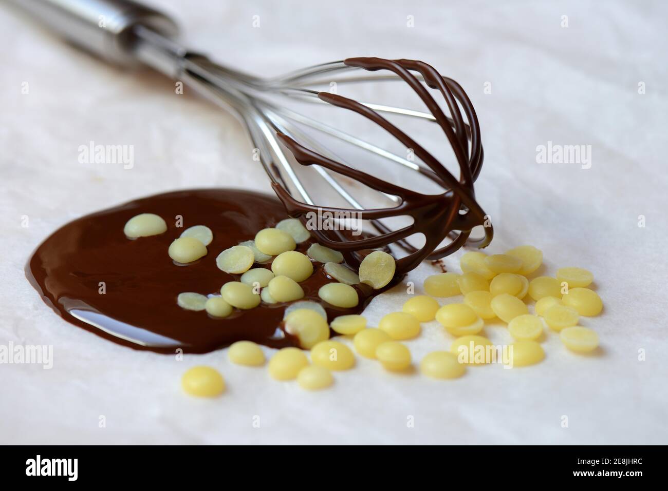 Cocoa butter and melted chocolate coating with whisk( Theobroma cacao) , cocoa, melted, chocolate ingredient Stock Photo
