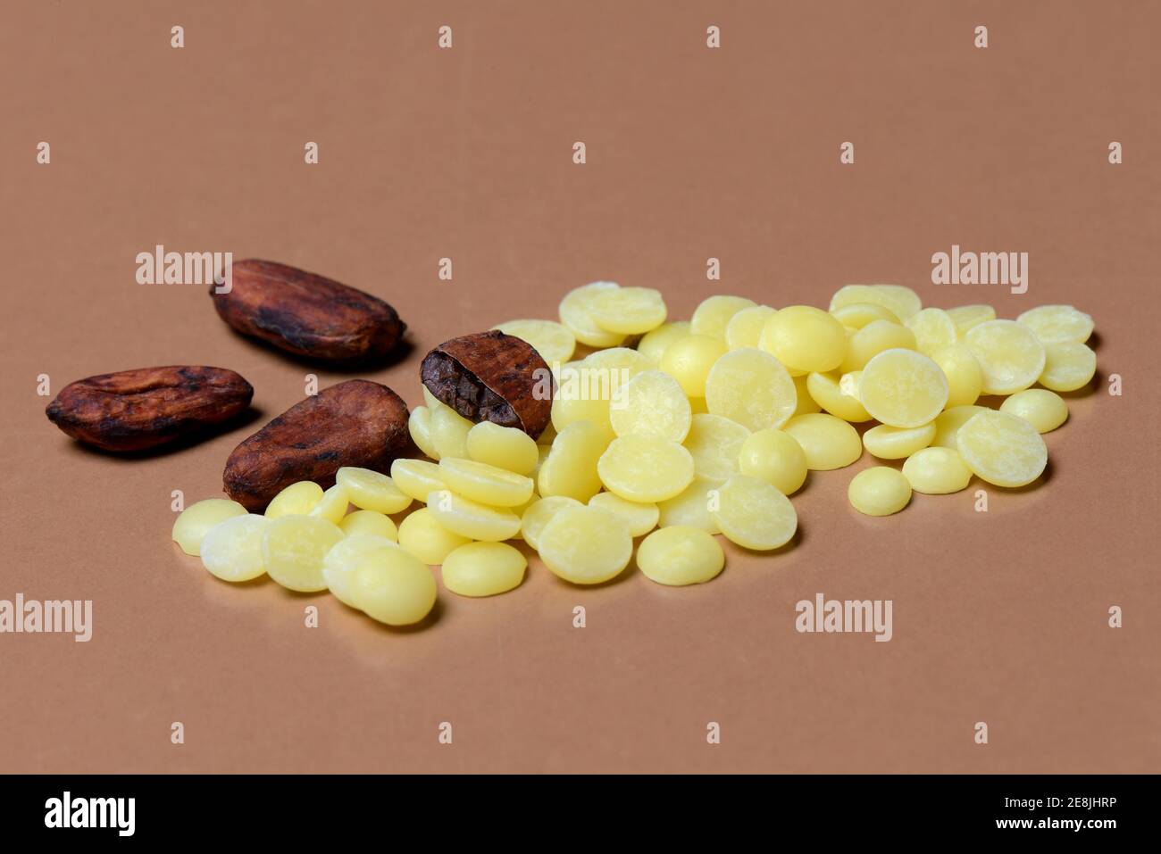 Cocoa butter chips and cocoa beans( Theobroma cacao) , chocolate ingredient Stock Photo