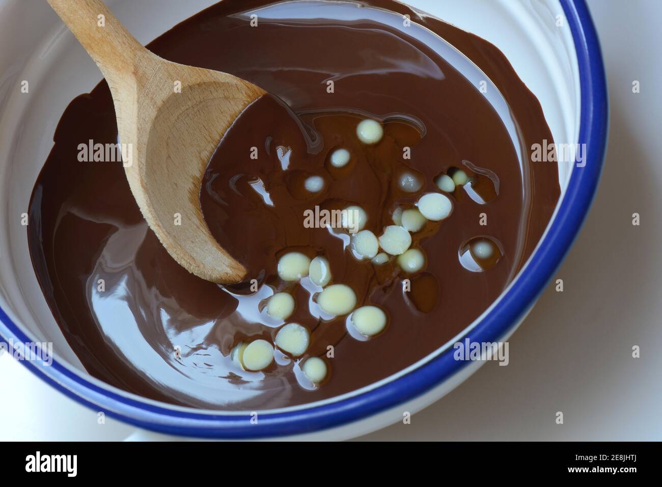Liquid chocolate coating and melting cocoa butter with spoon( Theobroma cacao) , oleum cacao Stock Photo