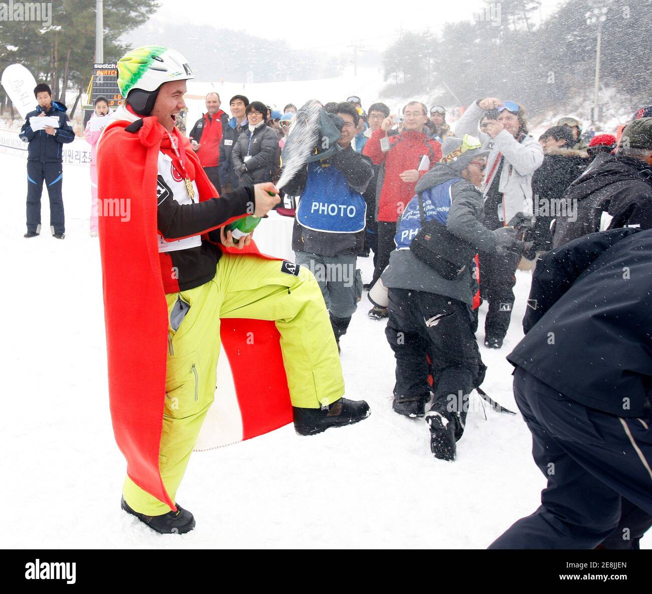 Markus Schairer (L) of Austria celebrates after winning the men's snowboard cross final at the FIS Snowboard World Championships in Hoengseong, east of Seoul, January 18, 2009.     REUTERS/Jo Yong-Hak  (SOUTH KOREA) Stock Photo